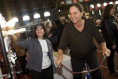 Peggy Peach uses the energy bike assisted by Carole Fisher