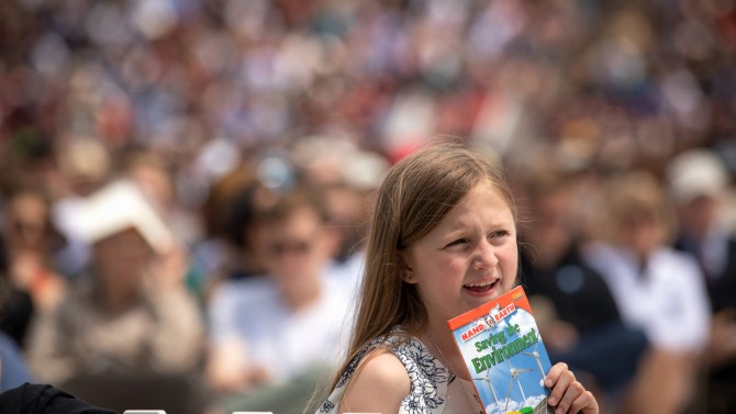 Young girl with environmental book