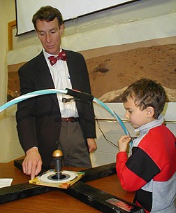 Bill Nye with Alex Walters explaining the details of a model of the sundial