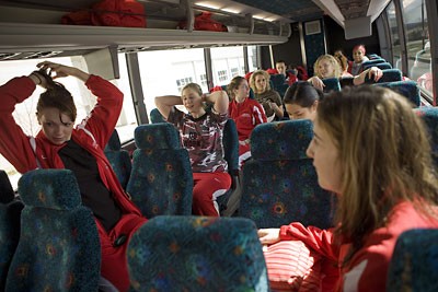 women's basketball team boards the bus
