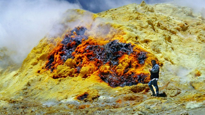 Geologist Jorge Clavero stands near a fumarole
