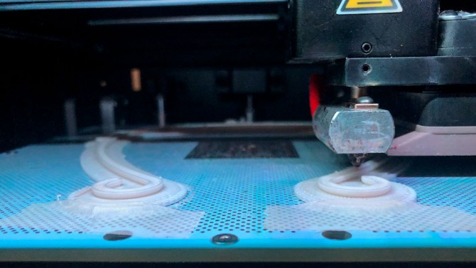 A closeup view of protective visors on a 3D printer