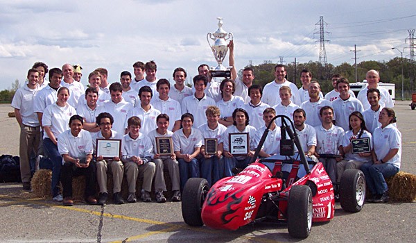 Cornell team proudly displays the winner's cup