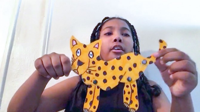 Girl holding cutout cheetah