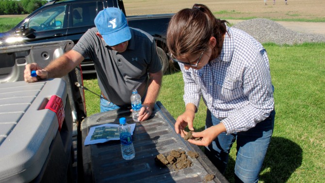 Cristine Morgan, right, director of the Soil Health Institute, looks at soil samples with Dairy Management Inc. 