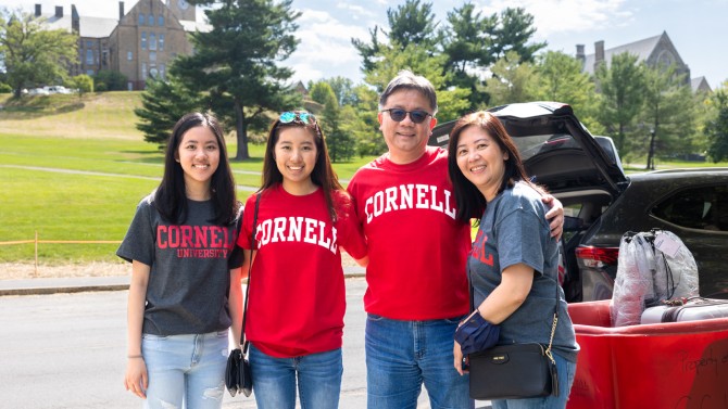 A family of four poses at Cornell.