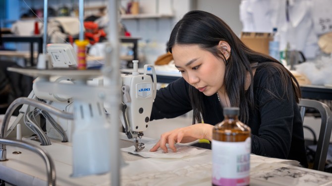 Alli Park ’23 works on their clothing line in a Human Ecology apparel studio ahead of the Cornell Fashion Collective show.