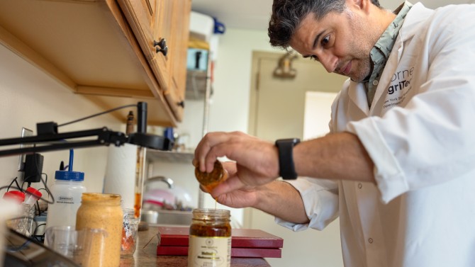 Bruno Xavier runs tests on a jar of Amish Agriculture shiitake mushroom sauce.