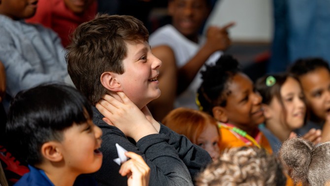 Students at Beverly J. Martin Elementary School listen to their peers present ideas for a new outdoor play space on May 8 at the school.