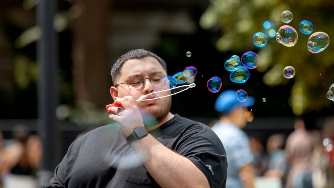 A guest sends bubbles across the Arts Quad.