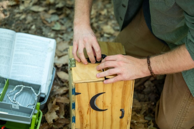 A wooden box built to look like a small outhouse to collect fecal samples from birds.