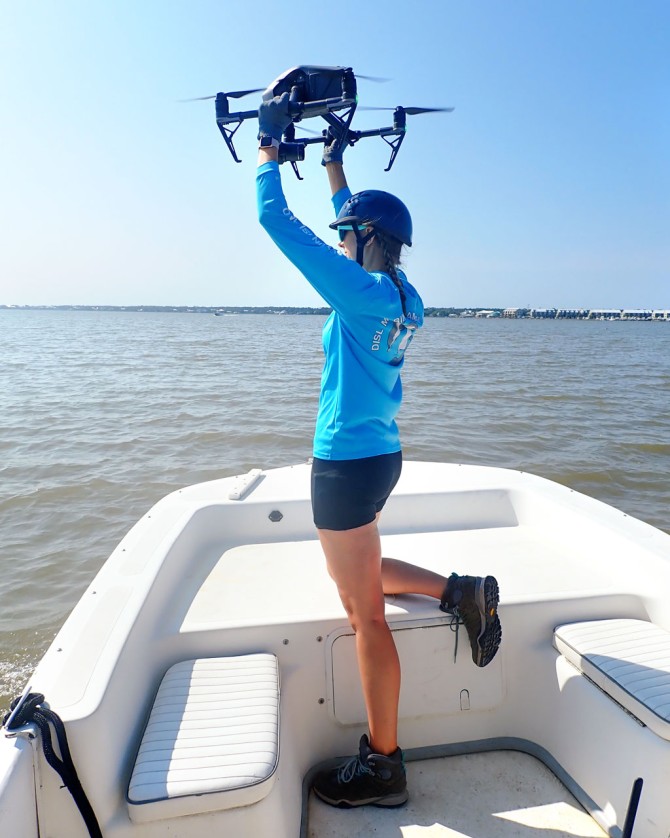 A Dauphin Island Sea Lab staff member launches a drone to search for decoys.