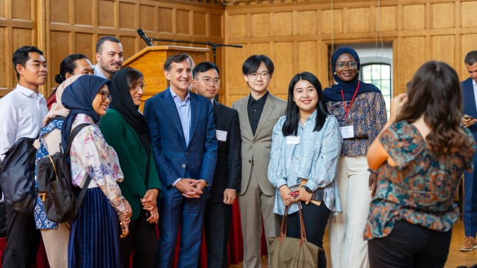 Johns Hopkins University President Ronald Daniels, stands for a photo with attendees at the first event hosted by the Cornell Jeb E. Brooks School of Public Policy's Center on Global Democracy.