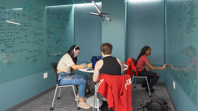 Students work on a project together in a Tang Hall study space.