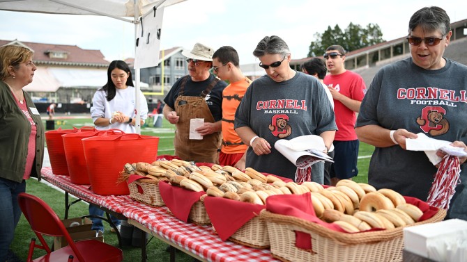 Members of the Cornell Community pick out food options from the bagels and yogurt station.