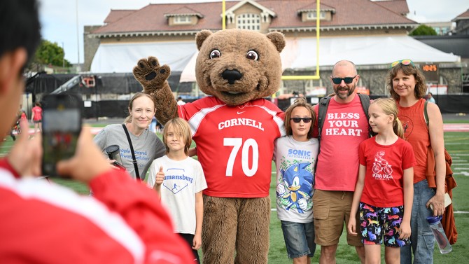 Families take photos with Cornell mascot, Touchdown.