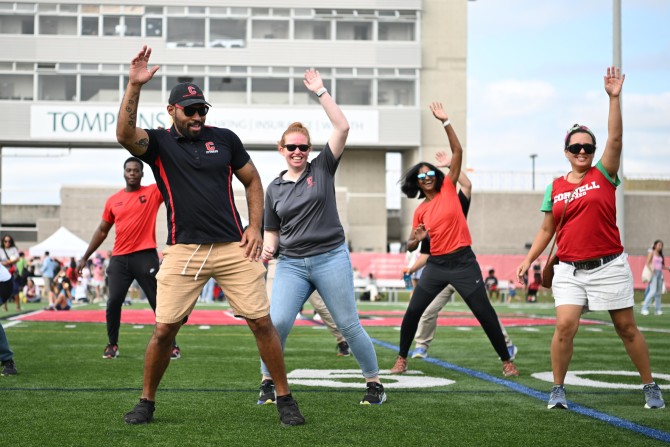 Cornell Athletics Associate Director of Facility Operations Jeremy Stewart dances along with the Zumba instructor.