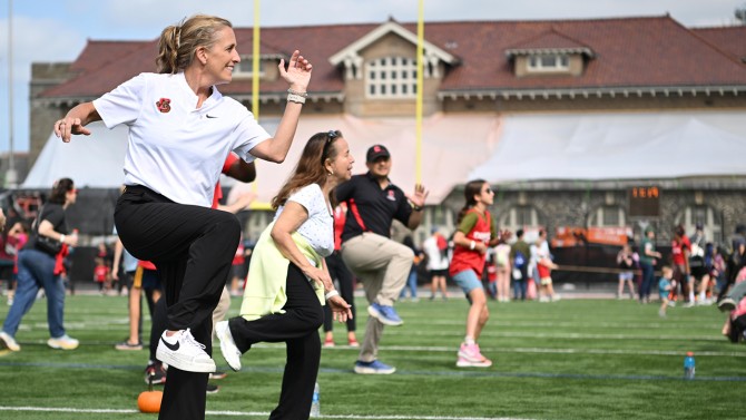 Cornell’s Director of Athletics Nicki Moore dances along with a Zumba instructor.