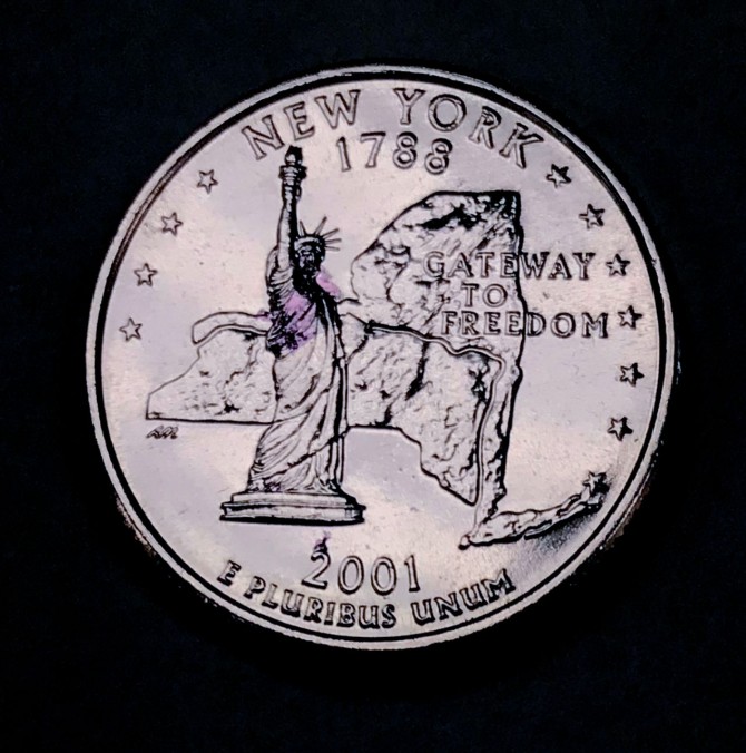 Researchers wrapped a millimeter-scale metasheet around a portion of the arm and body of the Statue of Liberty on a U.S. quarter. The metabot changed its shape to fit the contours of the statue.