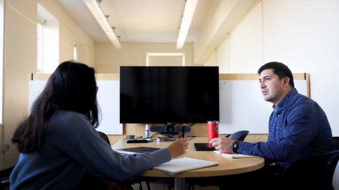 Charles meets with a graduate student in his lab in Riley-Robb Hall.