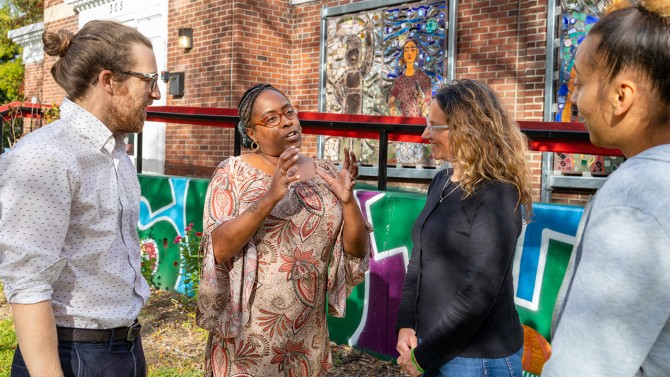 People chat outside the Southside Community Center in Ithaca, New York.