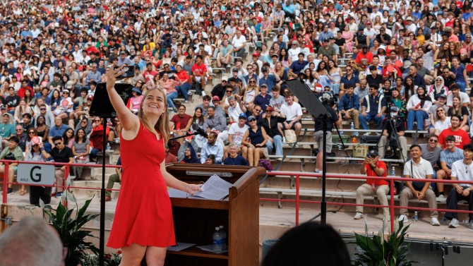 Zora deRham ’27, undergraduate president of the Student Assembly, takes a selfie with the crowd.