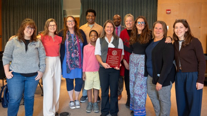 Mason poses with her colleagues during the ceremony in Mann Library.