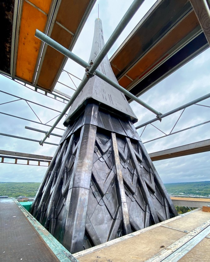 The fitting of the spire cap.