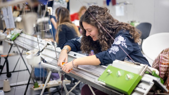 The class visited sheep farms and wool processors and spinners around New York. Fashion design major Liriana Nezaj ’27 drew inspiration from raw wood she saw there to design lacy socks reminiscent of wood grain.