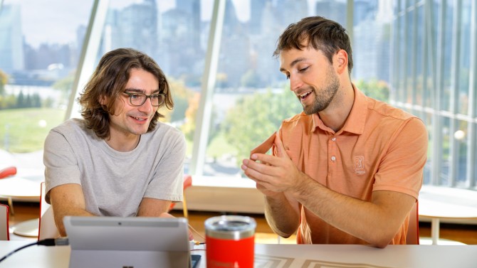 Jonathan Katz, a system engineer with SensVita, left, and Conroy discuss the latest model of the SensVita device.