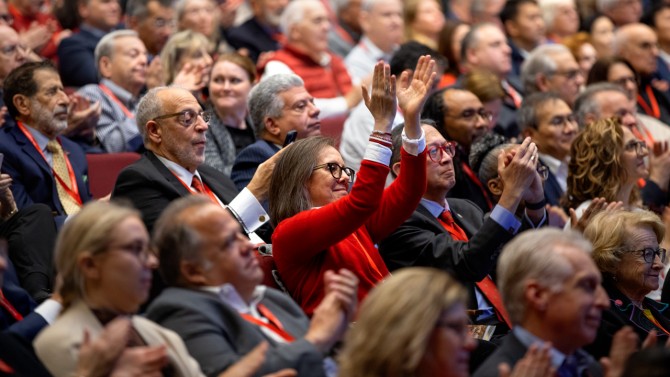 Trustees and University Council members applaud during President Michael I. Kotlikoff’s State of the University address, Oct. 24 in Call Auditorium