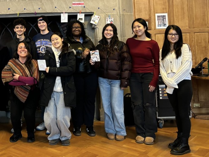 Eight Spanish language students hold up the zines they created for Zine Fest.