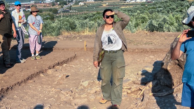 Uğurer presents her excavation trench during a tour. 