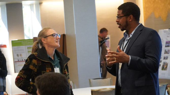 Hakim Weatherspoon, co-director of CIDA and professor of computer science in Cornell Ann S. Bowers College of Computing and Information Science, talks digital agriculture with workshop attendee.