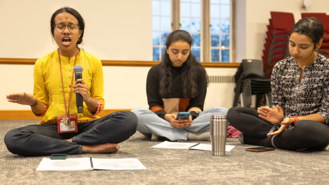 Shria Shyam, HSC executive board member and a doctoral student in Cornell Engineering’s School of Civil and Environmental Engineering, sings during the community’s weekly bhajan in the auditorium adjacent to the Hindu Temple room.