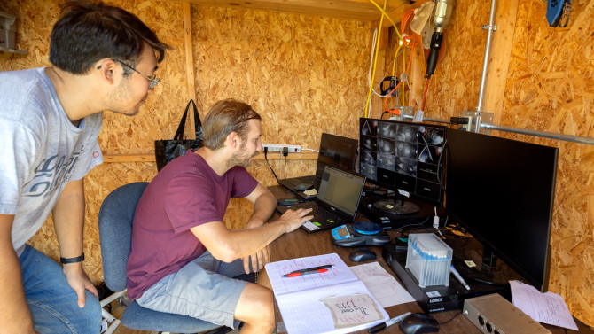 Co-author Daniel Chang Kuo ’23 (left) and postdoctoral researcher Matthew Zipple track the behavior and location of the rewilded mice.