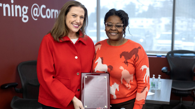 Christine Lovely (right), vice president and chief human resources officer, presented Artibee with the 2025 George Peter Award.