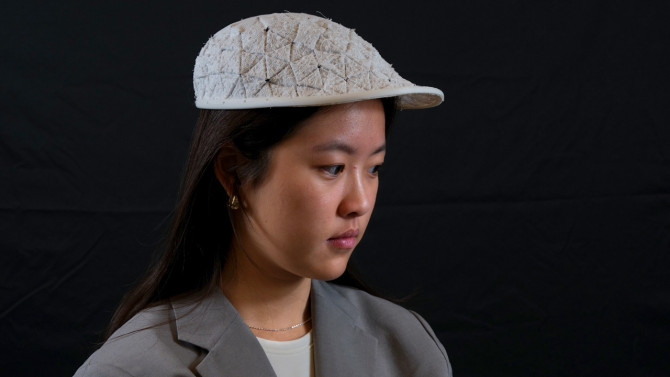 Xinyue Hu, a master's student at Cornell Tech, models a hat created with OriStitch, a new software and fabrication system developed by Cornell Tech researchers.
