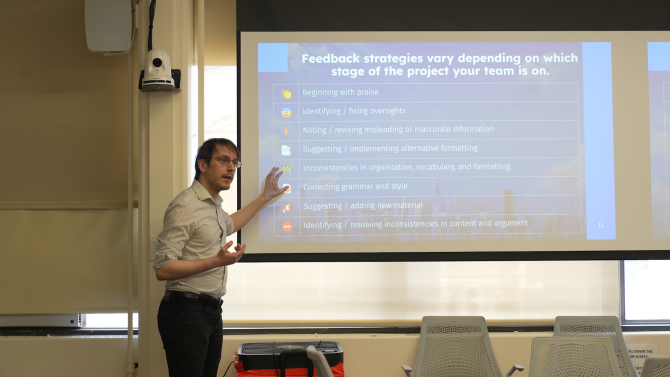 Cameron Mozafari, left, introduces feedback strategies to students on a powerpoint