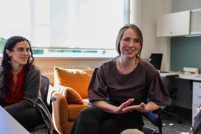 professor sits and talks to a student