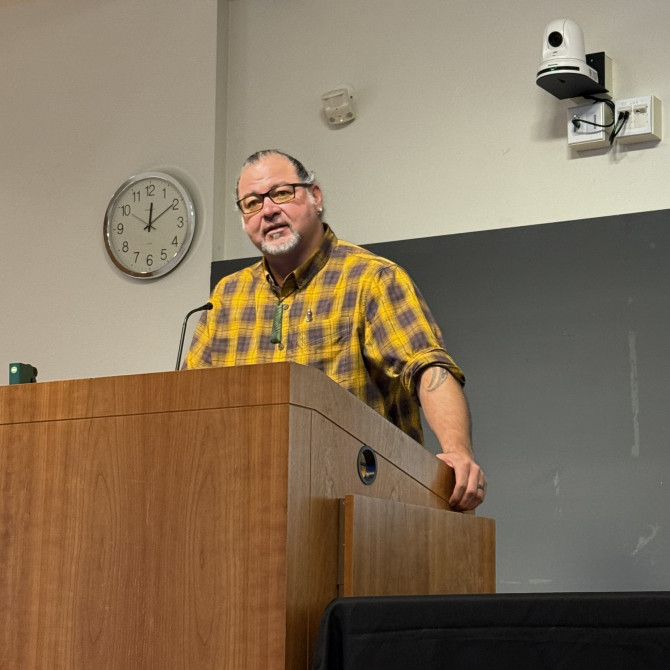 Sweeney Windchief stands behind a podium and gives the MAC Mentoring Keynote