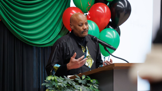 Kofi Acree, director of the John Henrik Clarke Africana Library and curator of Africana Collections for the Division of Rare and Manuscript Collections, welcomes guests to the community celebration.