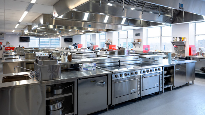 The remodeled teaching kitchen inside the Grailer Food Lab has 14 student work stations, a chef instructor station at the far end and all-electric appliances.