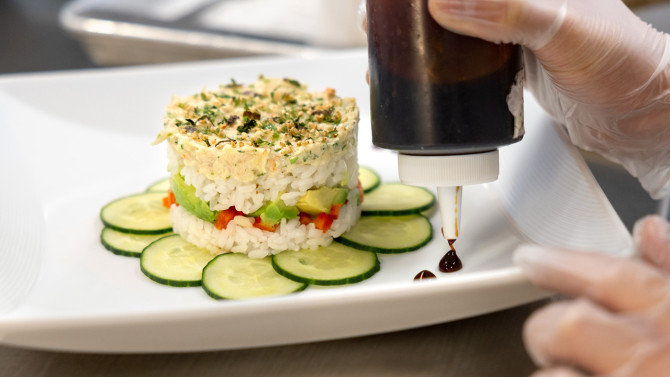 Chef assistants for the Restaurant Management course in the Cornell Peter and Stephanie Nolan School of Hotel Administration learned how to make a shrimp salad appetizer.