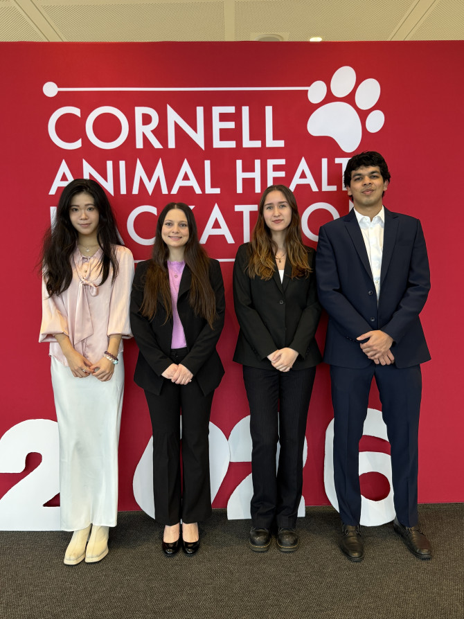 four people in front of a hackathon banner
