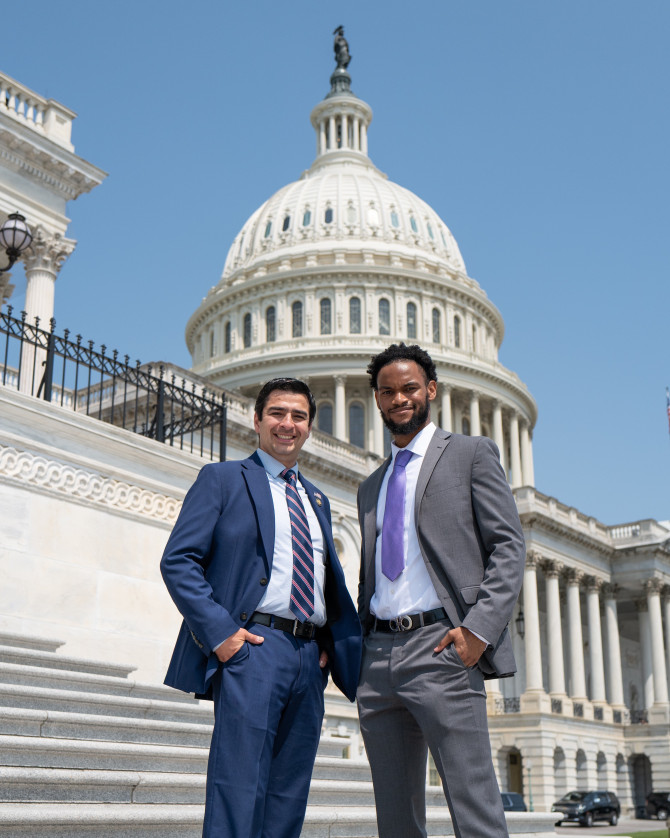 two people standing outside U.S. Capitol building