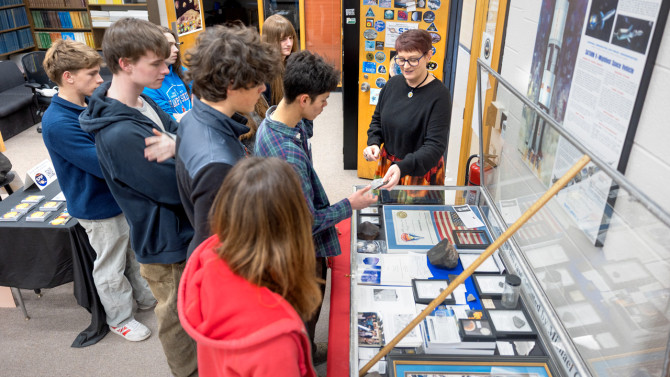 Zoe Learner Ponterio, manager of the Spacecraft Planetary Image Facility (SPIF), shares meteorite samples with students visiting from the New Visions program.