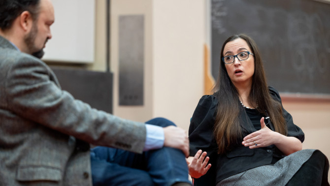 Kate Manne, right, professor of philosophy, debates with New York Times columnist Ross Douthat on the issue of declining fertility rates as part of the Disagreement course.