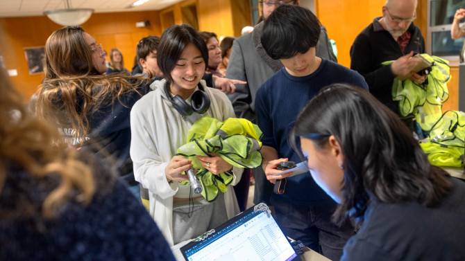 Volunteers pick up flashlights and reflective vests following a TCAMP training session on February 24 in Mann Library. Approximately 50 people attended the session - one of three the group organized - with another 39 people watching online. Bredin presented on species identification, patrolling protocols and how to collect data and help amphibians cross roads safely when necessary.