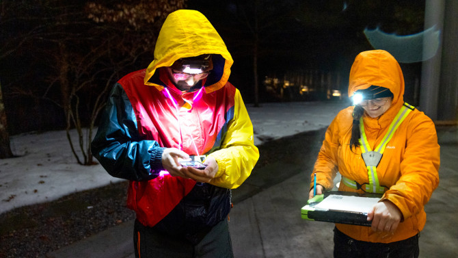 A Newt Hope team members Sam Rimm-Kaufman, MLA '25, and Kathy Stenehjem, a doctoral student in the field of ecology and evolutionary biology, record temperature, weather and road conditions on a waterproof data sheet before starting patrol on March 6.